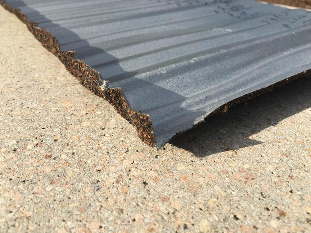 underside of new residential stone-coated metal roofing shingle