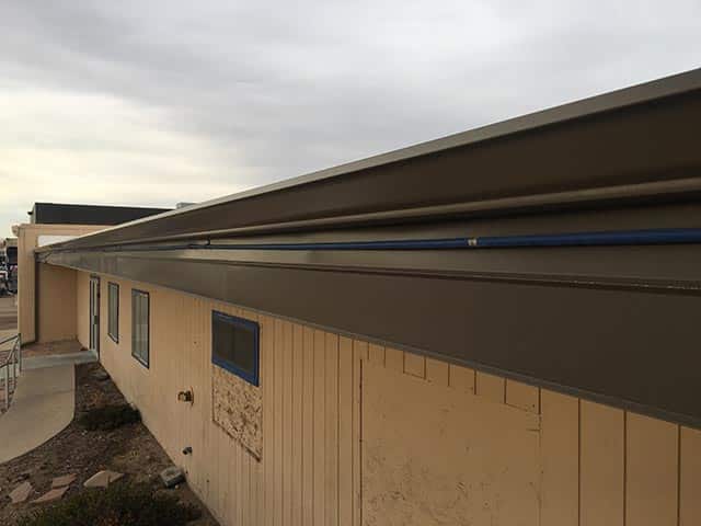 New seamless gutters and fascia on commercial building in Greeley