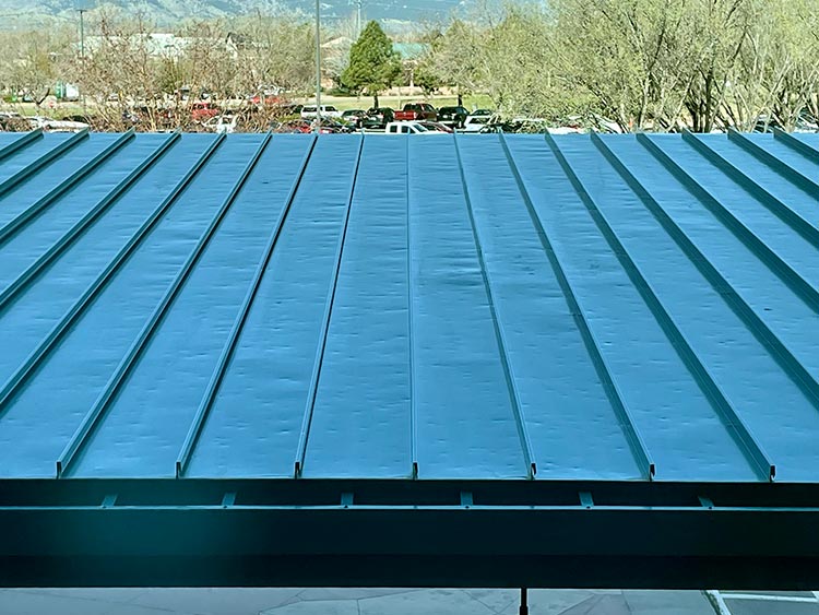 a standing seam metal roof with hail damage